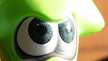 the eyes of a green squid figurine